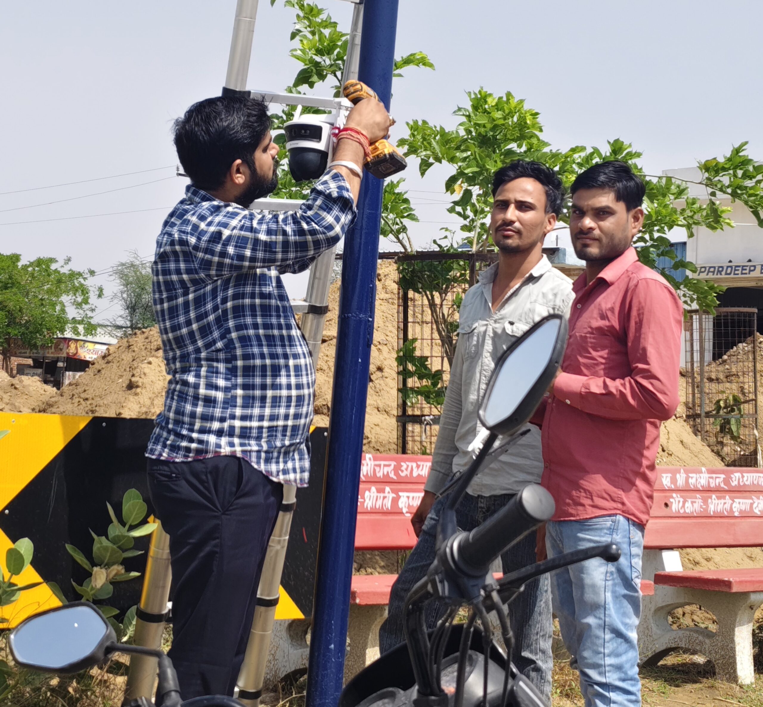 नांगल चौधरी में हाईटेक CCTV कैमरे लगाने का कार्य करते कर्मचारी।