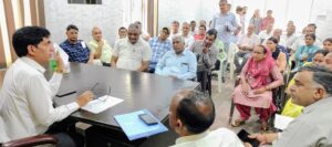 अधिकारियों की बैठक लेते एसडीएम डॉ जितेंद्र सिंह।