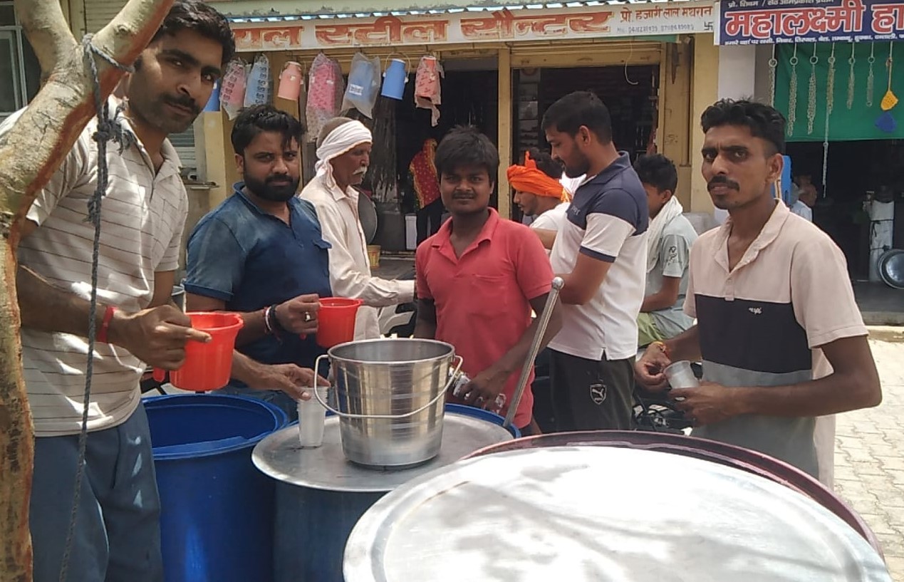 सतनाली में छबील पर राहगीरों को ठंडा मीठा पानी और शरबत वितरित करते दुकानदार एवं समाजसेवी।